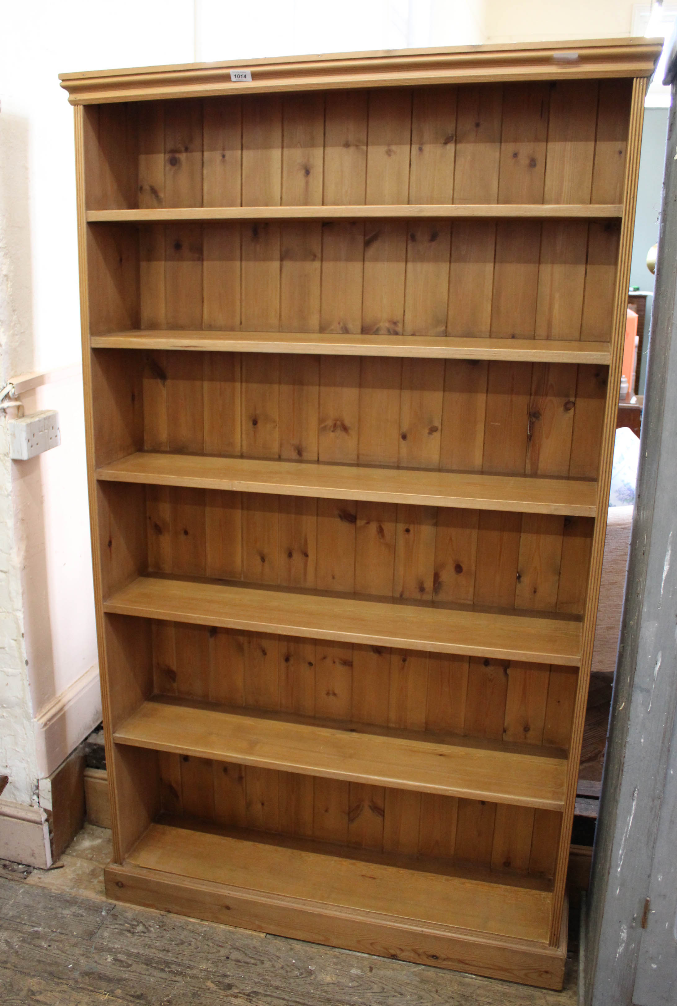 A late 20th Century stained pine bookcase with five shelves