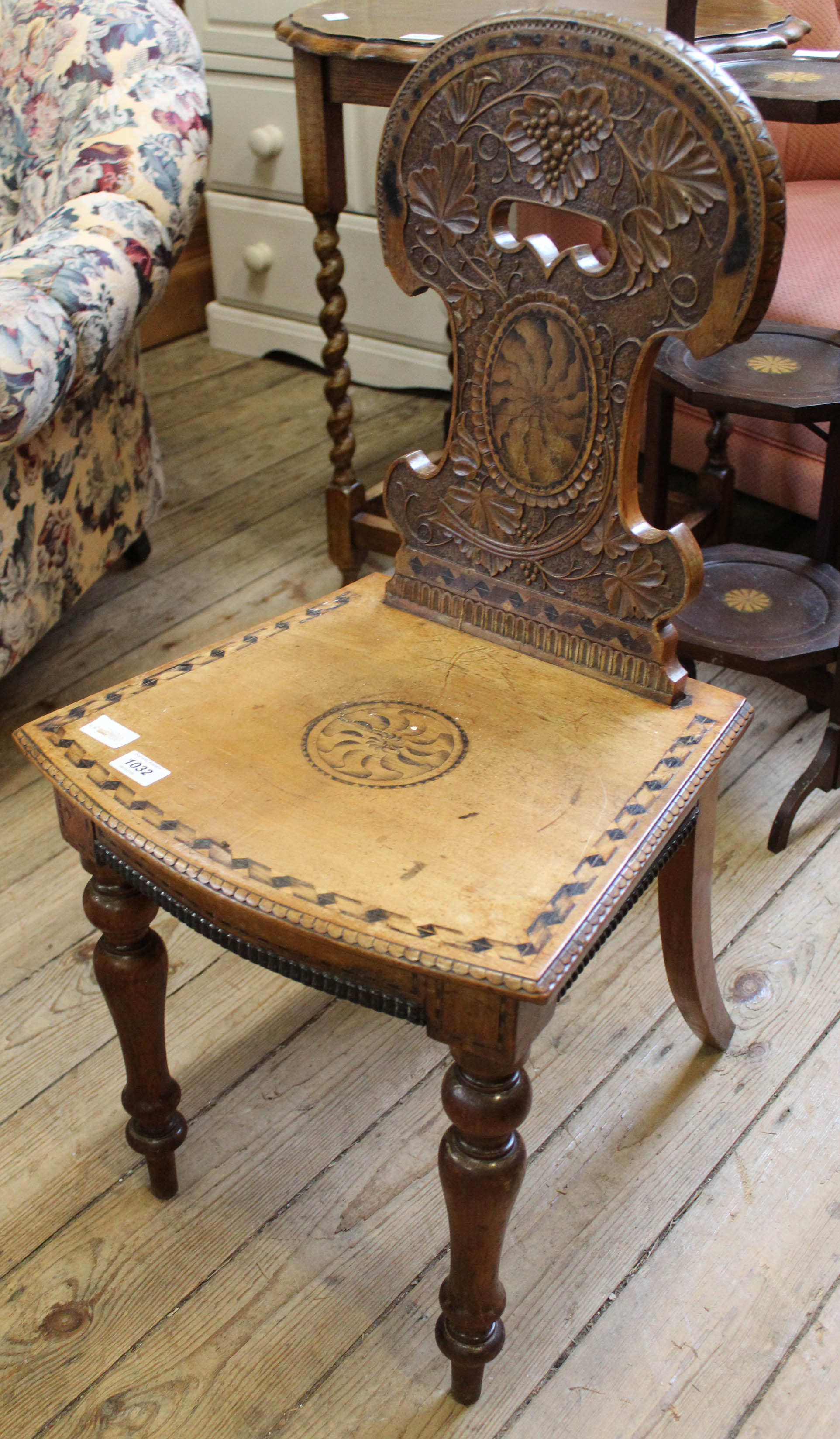 A Victorian carved and inlaid mahogany hall chair