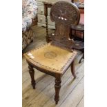 A Victorian carved and inlaid mahogany hall chair