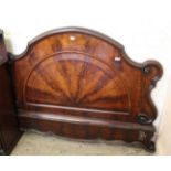 A late Victorian ornate flame mahogany headboard