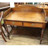 A late 19th Century mahogany two drawer writing table with galleried upstand