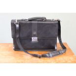 A vintage Dunhill black leather brief case with detachable shoulder strap and combination lock