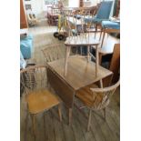A 1970's Ercol light teak flap leaf table and four Ercol cross stick back chairs