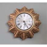 A vintage gold starburst clock