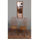 Two Ercol stick back chairs and a wall mirror