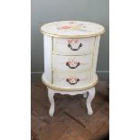 An unusual oval shaped chest of drawers with painted flower decoration