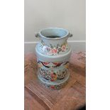 A painted blue and floral milk churn