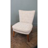 A cream upholstered 1950's style chair