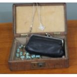 A small mock crocodile skin jewellery box containing a silver pendant,