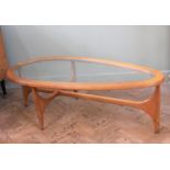 A teak eliptical glass top coffee table