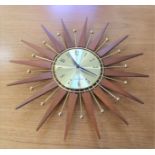 A vintage Seth Thomas starburst wall clock