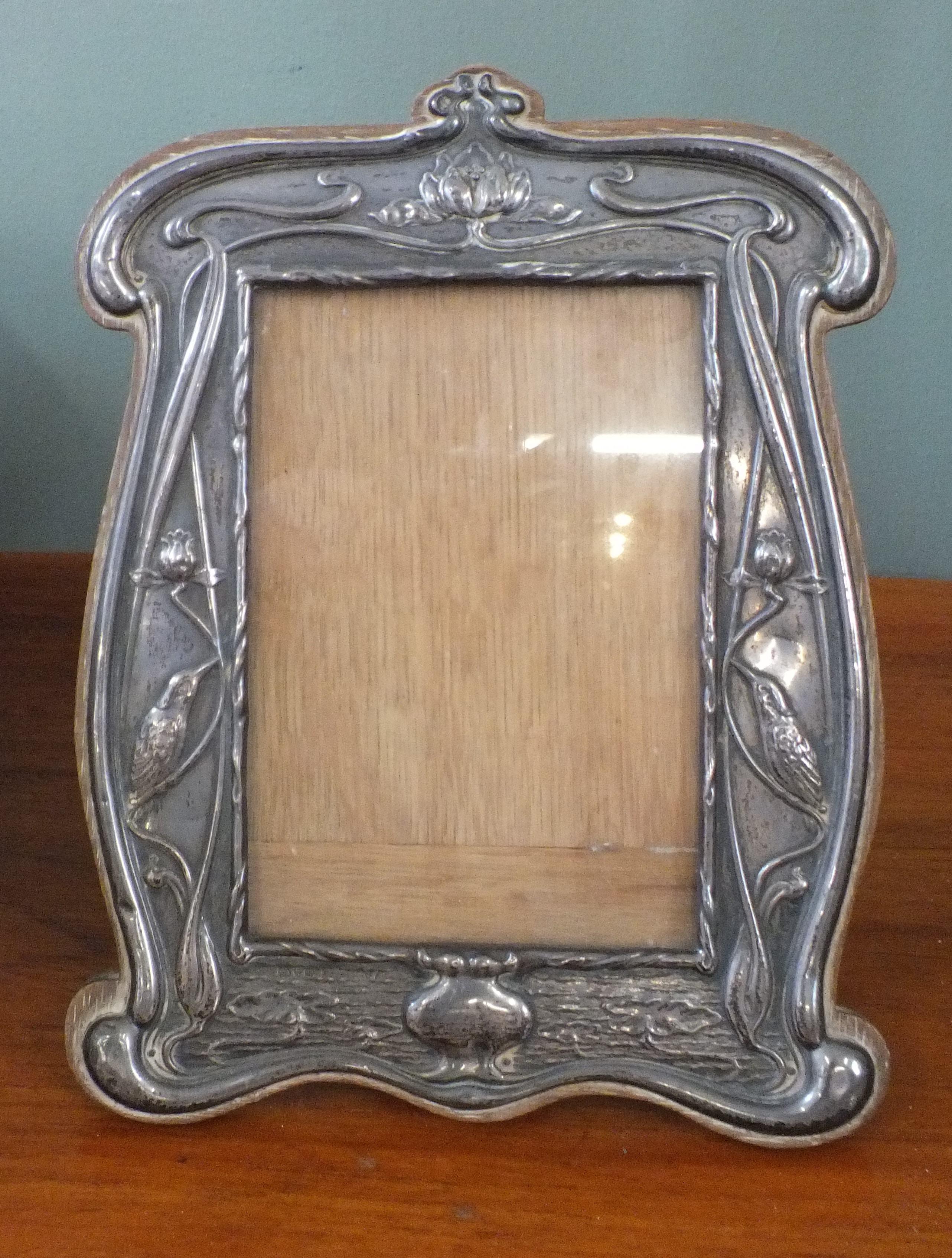 An Art Nouveau silver photo frame with kingfisher detail