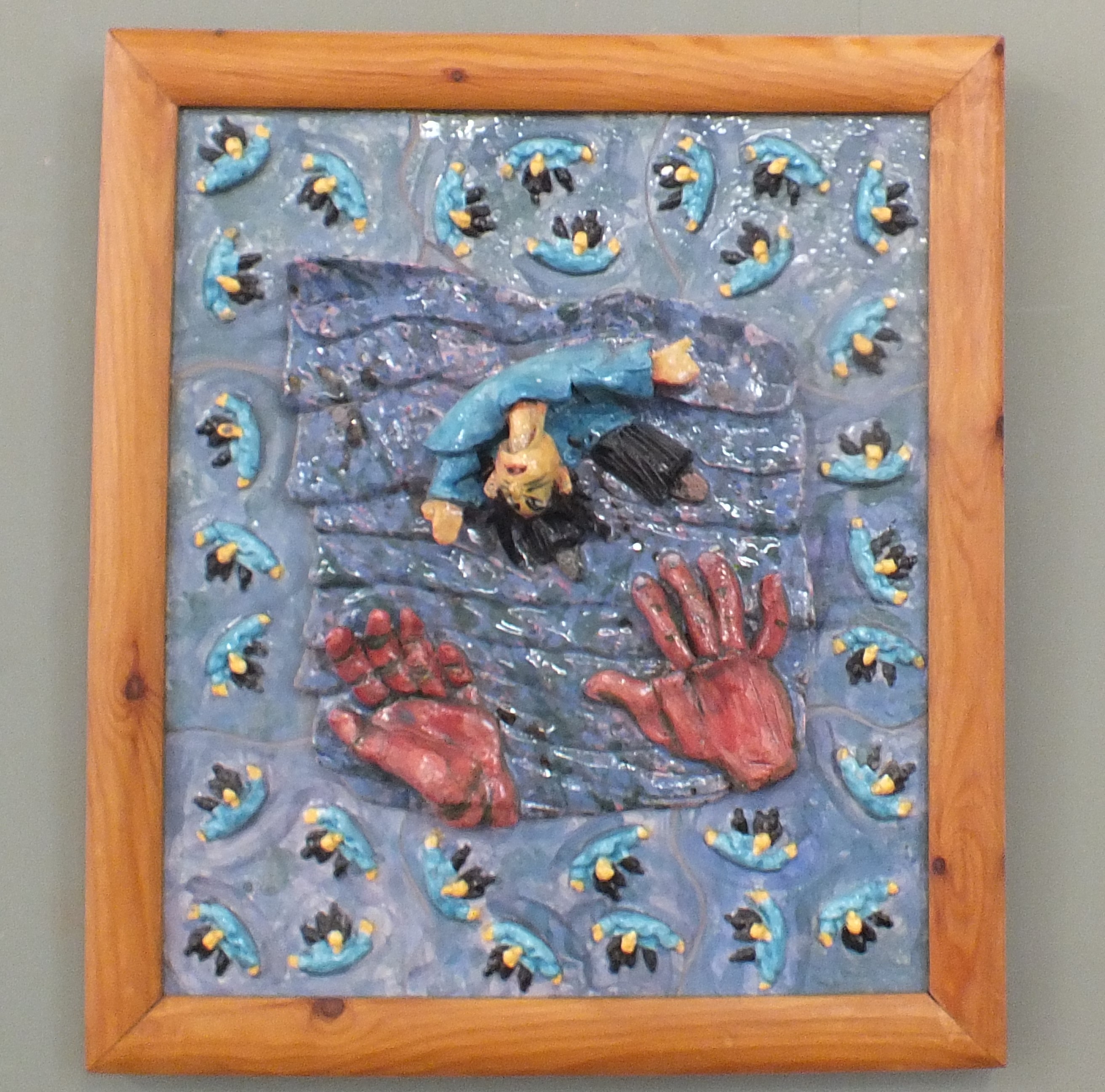 A framed grogged clay work "Puppet Jump" by Guy Richardson (part of the North Sea Magical Realist