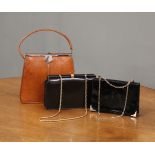 A vintage lizard skin handbag and two black patent leather bags with chain shoulder straps