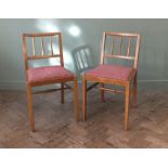 A set of three vintage wooden kitchen chairs with red check upholstery