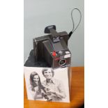 A Polaroid Super Swinger hand camera in original box