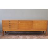 A Robert Heritage Hamilton range light teak sideboard, with four drawers and two sliding doors,