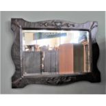 An Art Nouveau hammered copper wall mirror