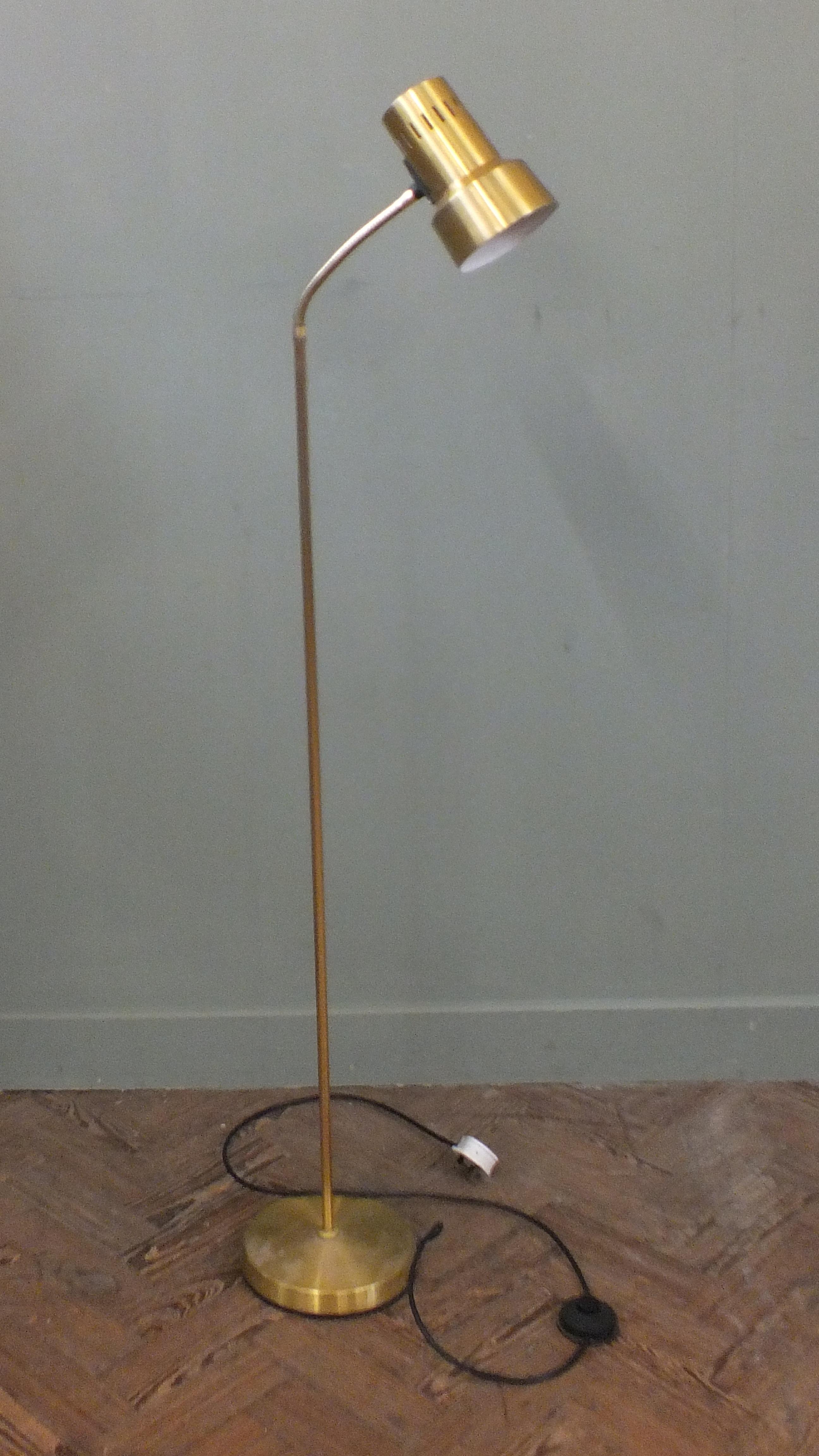 An adjustable gold spot light floor lamp.