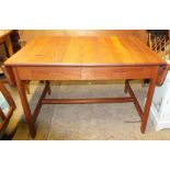 A small dining table with stretcher base,