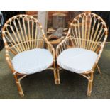 A pair of vintage bamboo conservatory armchairs and matching circular table