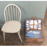 A wicker picnic hamper and a painted Ercol stick back chair