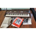 A Casiotone 701 1980's keyboard with manual, music stand and a quantity of sheet music.