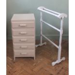A small painted chest of five drawers and a painted towel rail