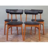 A set of four Danish style wood and black vinyl dining chairs
