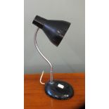 An adjustable black metal Herbert Terry desk lamp