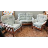 A Parker Knoll style wooden framed two seater sofa and armchairs in pale green floral upholstery