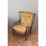 A vintage Ercol armchair with gold upholstery