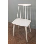 A single white painted stick back chair