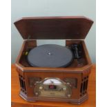 A Steeple tone record play/cassette player in the form of an vintage radio.