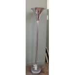 A substantial chrome and metal floor lamp with trumpet shaped shade.