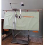 A vintage Zucor G65 architect's drawing board on metal stand with articulated lamp.