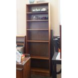 A tall teak effect bookcase