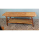 A 1970's style slim rectangular coffee table with under tier