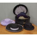 A hatbox with assorted hats