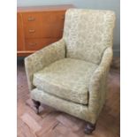 A green upholstered armchair