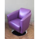 A purple leather armchair on chrome swivel base