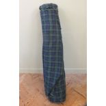 A roll of blue/green tartan fabric