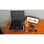 A small portable record player, various radios and a head set.