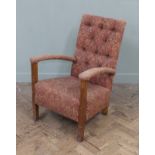 A 1930's dark red paisley upholstered armchair