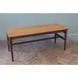 A 1970's rectangular coffee table with stretcher base and unusual sliding top with compartment