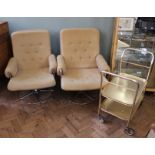 Two 1970's chrome frame swivel armchairs and a drinks trolley