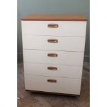 A 1970's cream and brown chest of five long drawers
