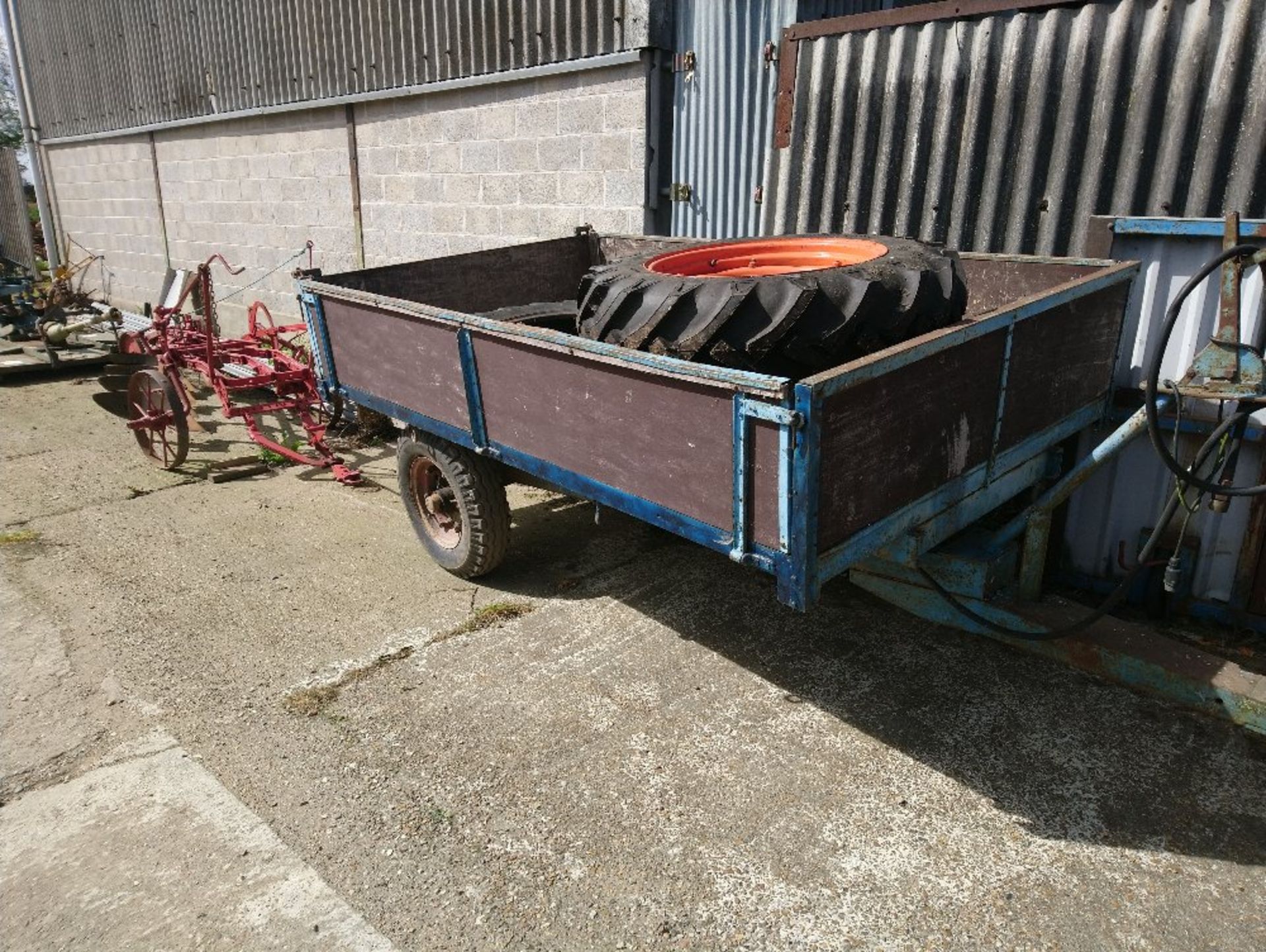 Single axle hydraulic tipping trailer- planked timber deck with plyboard removable sides.