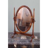 An Edwardian mahogany swing mirror,