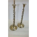 A pair of tall Edwardian open barley twist brass candlesticks with detachable sconces and domed